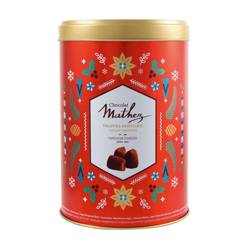 Mathez French cocoa dusted truffles in a red Christmas-themed tin, featuring elegant packaging from Jag Couture London New York
