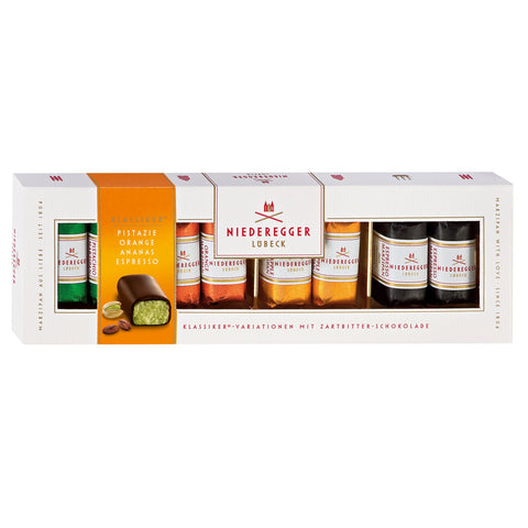 Dark chocolate covered mini marzipan loaves with pistachio, orange, pineapple, and espresso flavors in a gift box by Jag Couture London New York.