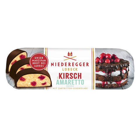 Dark chocolate covered marzipan loaf with kirsch and amaretto flavor, crafted by Jag Couture London New York, shown sliced with marzipan filling.