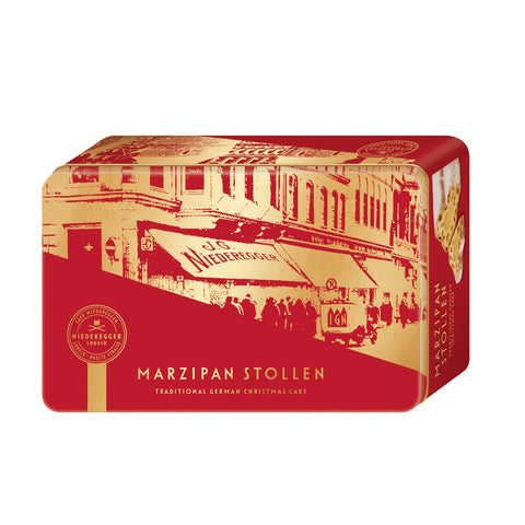 Marzipan stollen fruit loaf in gift tin from Jag Couture London - New York, showcasing sliced marzipan-filled Christmas cake