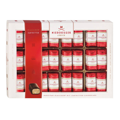 Dark chocolate covered mini marzipan loaves from Jag Couture London - New York in an elegant gift box, showcasing a luxurious confectionery display.