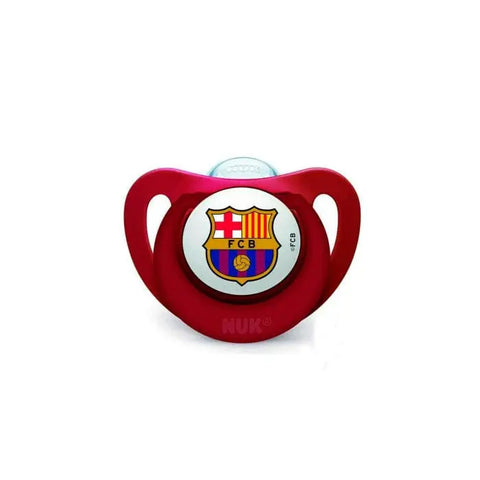 Silicone pacifier with FC Barcelona logo for 6-18 months, by Nuk, featuring a comfortable silicone teat and vibrant team design.