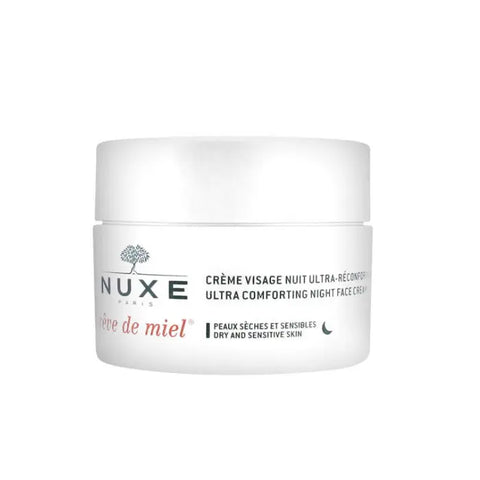 Nuxe Rêve De Miel Ultra Comfortable Night Face Cream jar with golden lid and label, next to honeycomb and flowers.