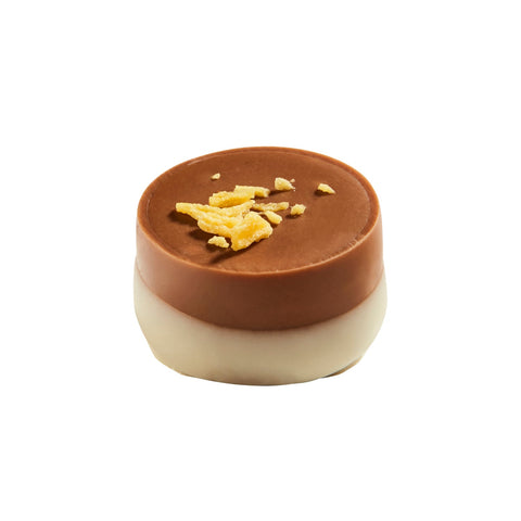 Ravel milk chocolate cup filled with Grand Marnier ganache, 15g, by Jag Couture London New York, displayed on a white background.