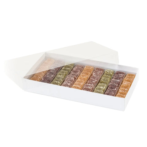 Assorted fruit pâte de fruits cubes in apricot, lemon, strawberry, raspberry, and pear flavors, packaged in 12g size by Jag Couture London New York.