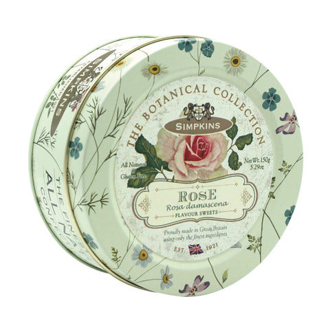 Botanical tin of rose-flavored travel sweets by Jag Couture London New York, featuring colorful floral packaging and assorted candies inside.