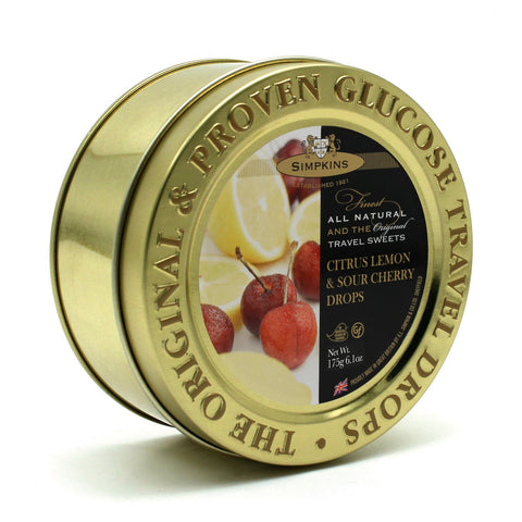 Gold embossed tin of citrus flavor travel sweets by Jag Couture London - New York, featuring colorful citrus candies inside.
