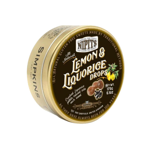 Gold tin of Nipit travel sweets with lemon and liquorice flavor from Jag Couture London – New York, featuring colorful candies inside.