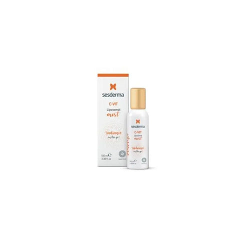 Sesderma C-Vit Mist Boost Illuminator spray bottle with bright orange label, 100ml, held by a person.