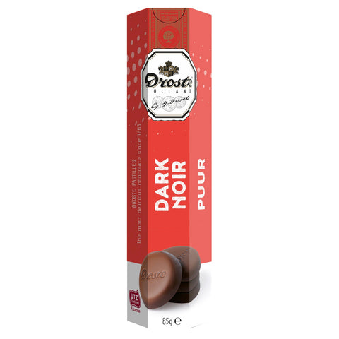 Dark chocolate pastilles in a tube by Jag Couture London – New York, showcasing glossy, rich chocolate treats inside a sleek container.