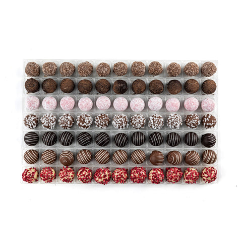 Assorted Jag Couture London English truffle chocolates including milk caramel, dark rum, pink gin, and white champagne.