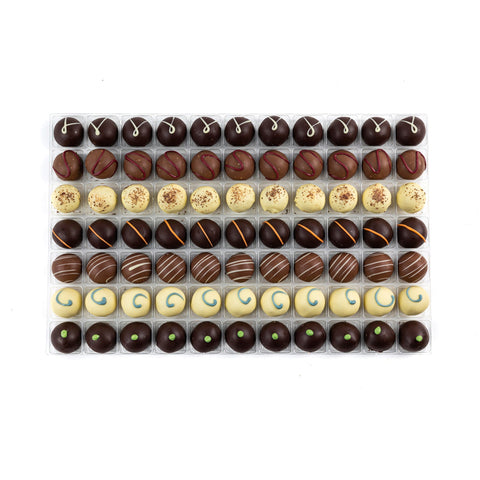Assorted premium English truffle chocolates with flavors like gin & lime, blueberry, champagne, cappuccino, cherry bakewell, and apricot.