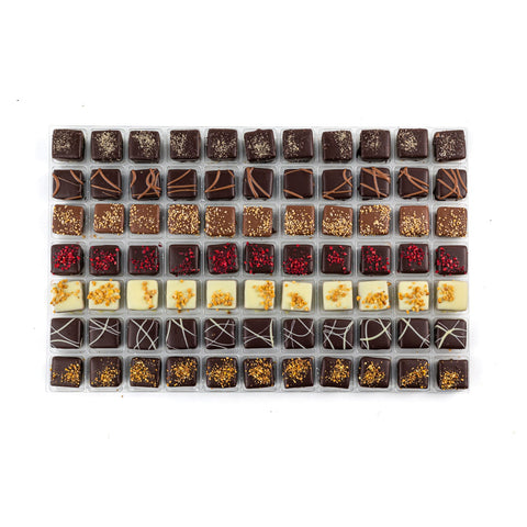 Assorted chocolates from Jag Couture London - New York, including salted caramel, raspberry, milk caramel, lemon, and bresilienne flavors.