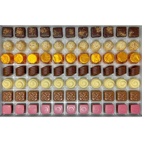 Assorted jag couture London pralines featuring dark lemon, white hazelnut, salted caramel, apricot, Irish cream, raspberry, and pistachio