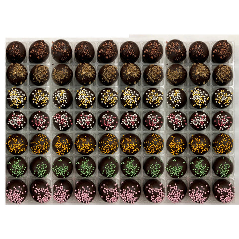 Vegan truffles selection by Jag Couture London-New York featuring coffee, spiced rum, champagne, cherry Bakewell, orange, lime, and raspberry flavors.