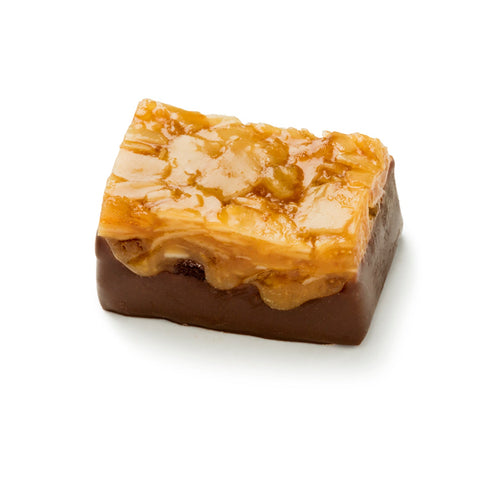 Assorted dried fruits with caramel and almonds dipped in dark chocolate, 10g pieces, arranged in a box.