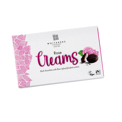 Dark chocolate covered rose fondant creams in a carton by Jag Couture London - New York, showcasing the elegant confections inside.