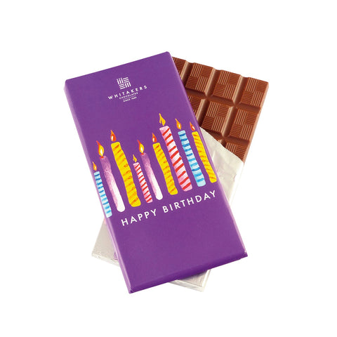 Whitakers milk chocolate bar with birthday candles wrapper, featuring colorful birthday cake design and festive decoration.