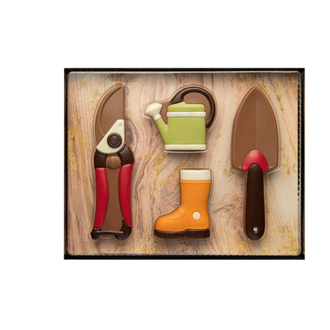 Decorated hollow milk chocolate gardening gift set by Jag Couture London New York, featuring detailed chocolate garden tools and accessories.