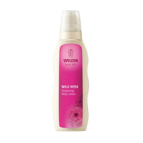 Weleda Wild Rose Pampering Body Lotion bottle with pink rose design, 200ml, featuring elegant packaging from Jag Couture London New York.