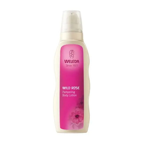 Weleda Wild Rose Pampering Body Lotion 200ml bottle with pink rose design, placed on a soft, neutral background.