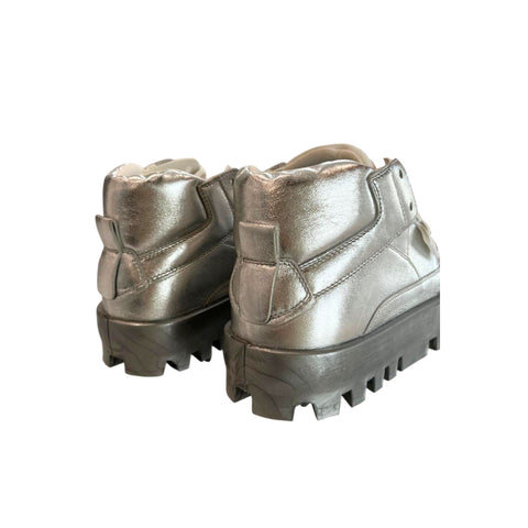 Silver jewelry piece from Jag Couture London New York, featuring intricate design and polished silver finish.