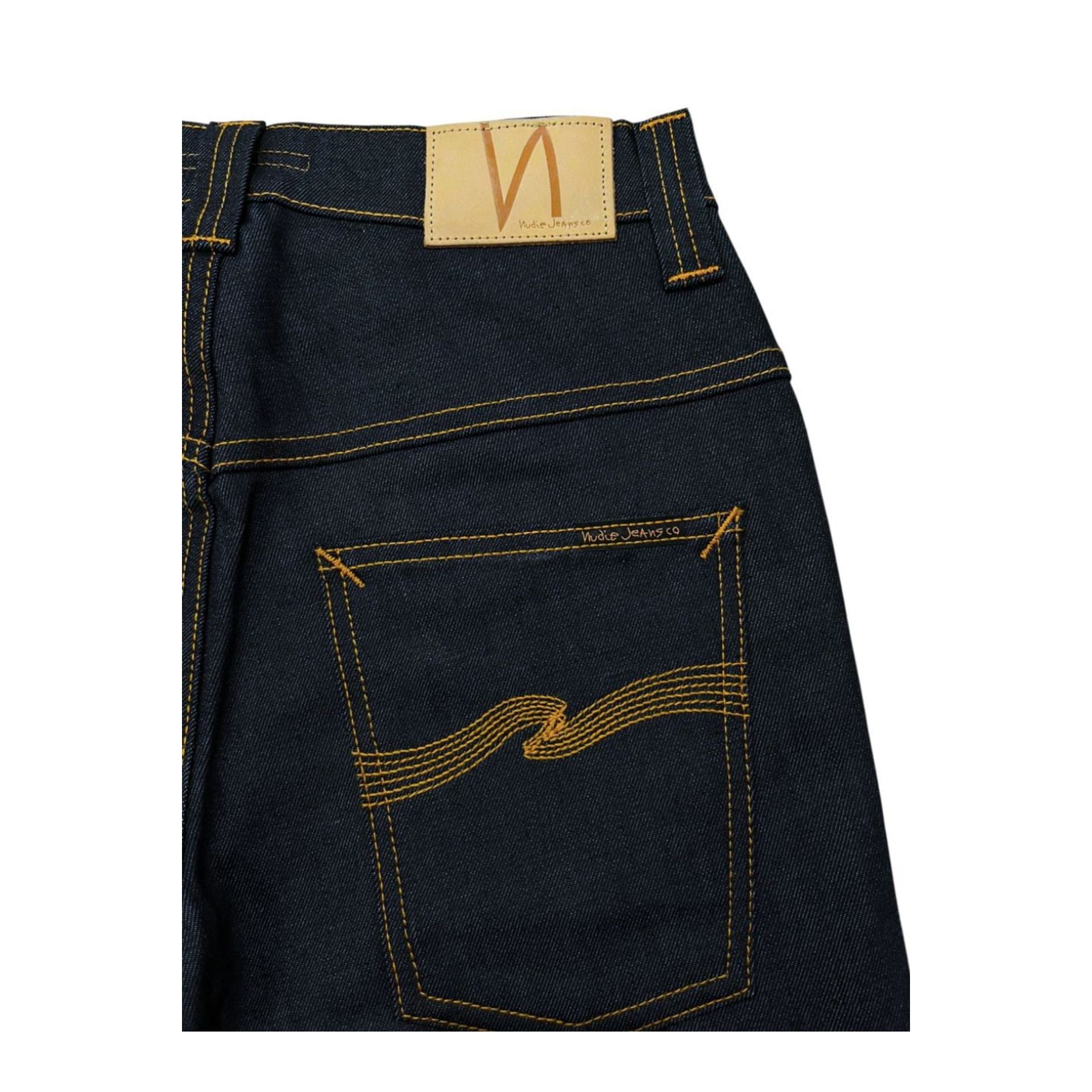 Nudie Jeans NJ4229 Tapeted BluNavy denim jeans with taper fit, shown on a hanger, featuring dark blue wash and subtle stitching details.