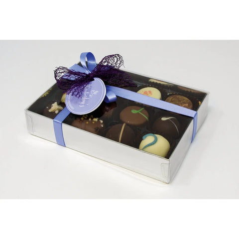 Assorted handmade English truffles and chocolates in a silver gift box with menu tag by Jag Couture London New York.