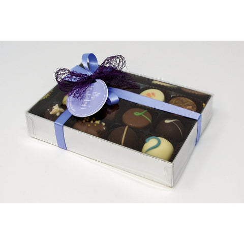 12 handmade English chocolates and truffles from Jag Couture London in a silver gift box with a menu tag.