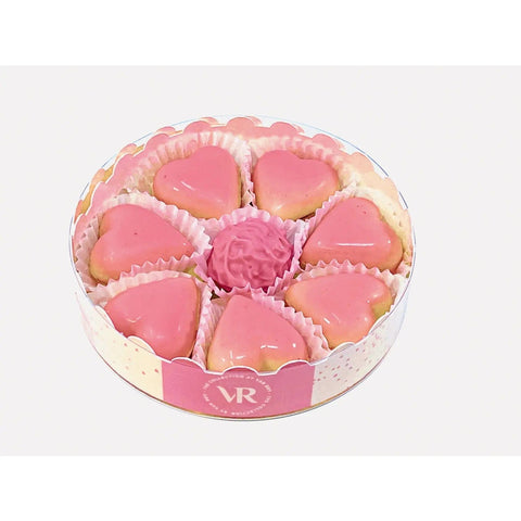 12cm round gift box by Jag Couture London features caramel-filled blushed hearts and Marc de Champagne truffles.