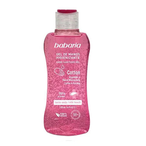 Babaria Cotton Sanitizing Hand Gel with 70% alcohol, 100ml bottle, held in hand, featuring clear label and white cap.