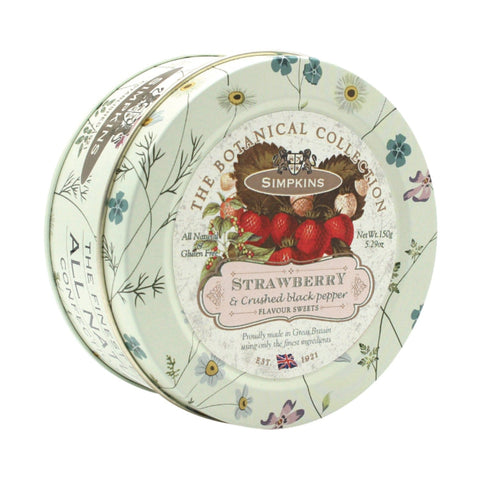 Botanical tin of strawberry and pepper flavored travel sweets by Jag Couture London - New York, featuring colorful packaging and sweets inside.