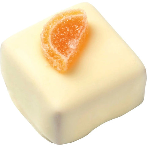 Bouche orange white by Jag Couture London-New York with orange ganache topping, garnished with a slice of fresh orange.