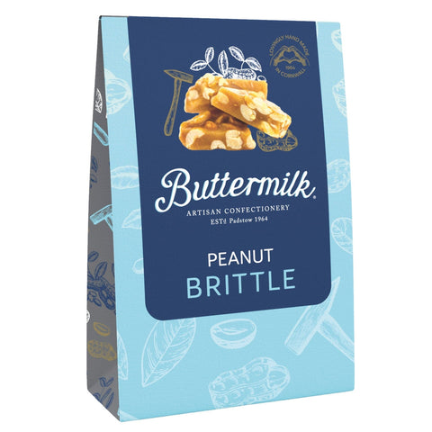 Buttermilk crunchy peanut brittle from Jag Couture London in a sharing box, showing golden brittle pieces with peanuts inside.