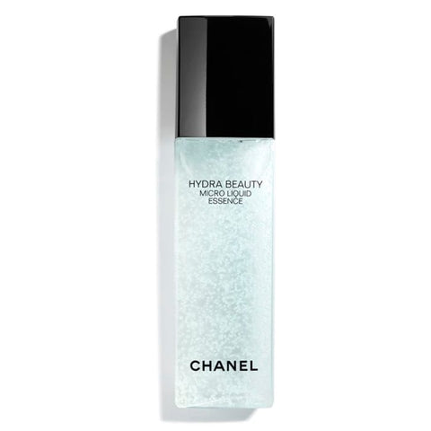 Chanel Hydra Beauty Micro Liquid Essence 150ml in clear bottle with droplet applicator, displayed on a sleek stand.
