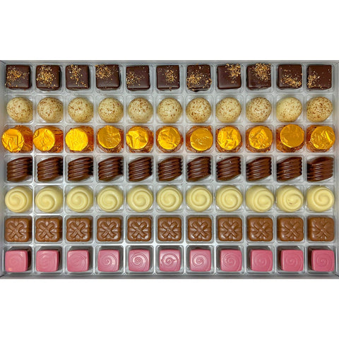 Jag Couture London praline selection featuring dark lemon, hazelnut, salted caramel, apricot, Irish cream, raspberry, and pistachio pralines.