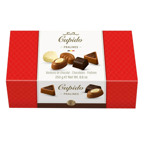 Assorted chocolates in a Cupido carton by Jag Couture London New York, featuring a variety of colorful, individually wrapped chocolates.