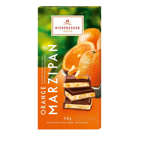 Dark chocolate-covered orange-flavored marzipan bar by Jag Couture London New York, showcasing the glossy coating and citrus-infused interior.