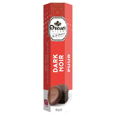 Dark chocolate pastilles from Jag Couture London in a sleek tube, showcasing glossy, rich chocolate pieces ready to enjoy.