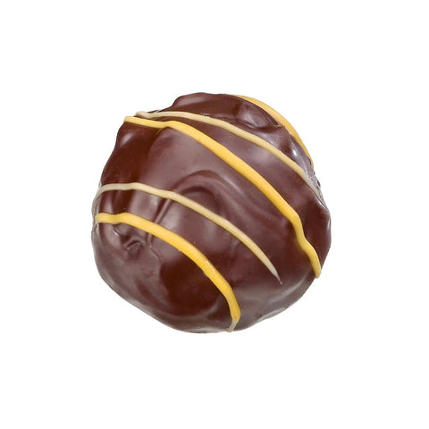 Dark orange truffle with orange ganache from Jag Couture London, showcasing its vibrant color and rich, glossy coating.