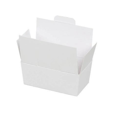 Two white chocolate ballotins with lock top from Jag Couture London New York, elegant packaging for chocolates.