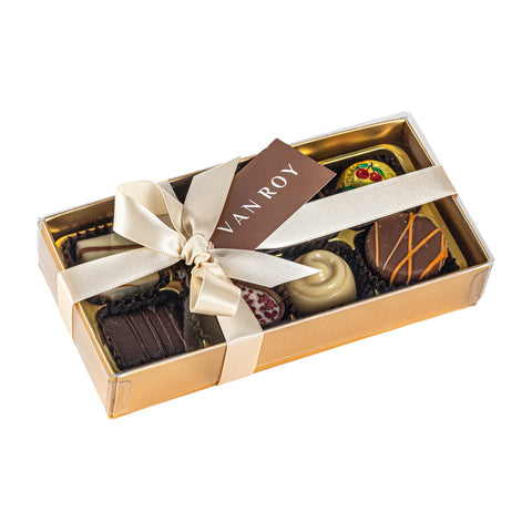 Assorted Belgian chocolates in gold box with acetate lid and ribbon, by Jag Couture London - New York.