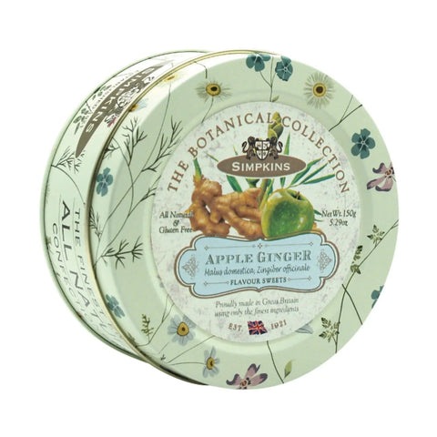 Botanical tin of apple and ginger flavored travel sweets by Jag Couture London - New York, featuring colorful packaging and assorted candies.