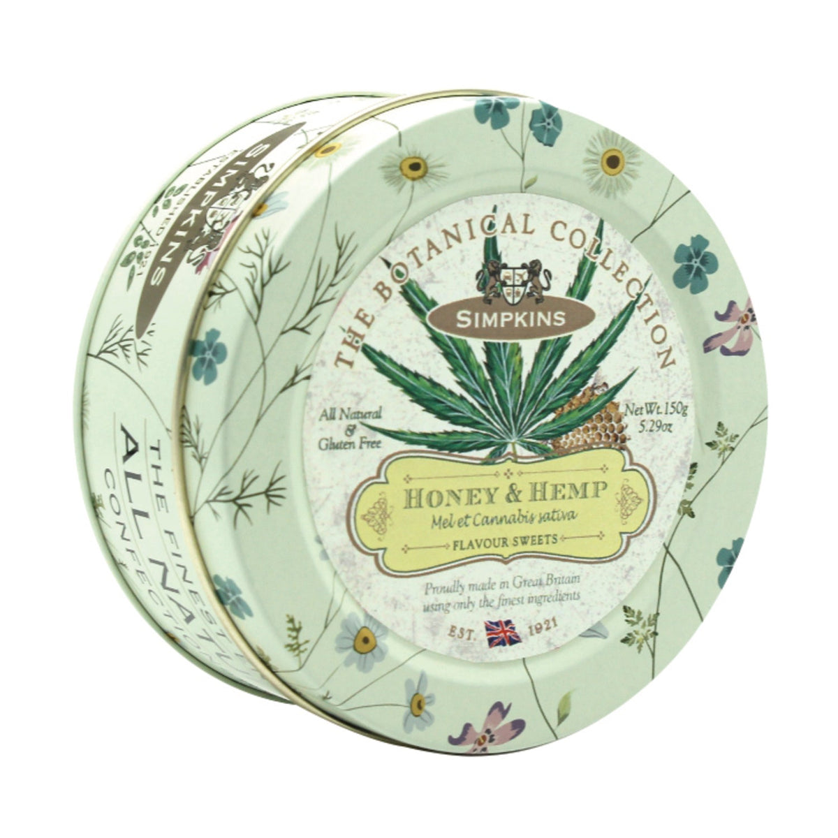 Botanical tin of honey and hemp flavored travel sweets by Jag Couture London New York, featuring colorful packaging and sweet treats inside.