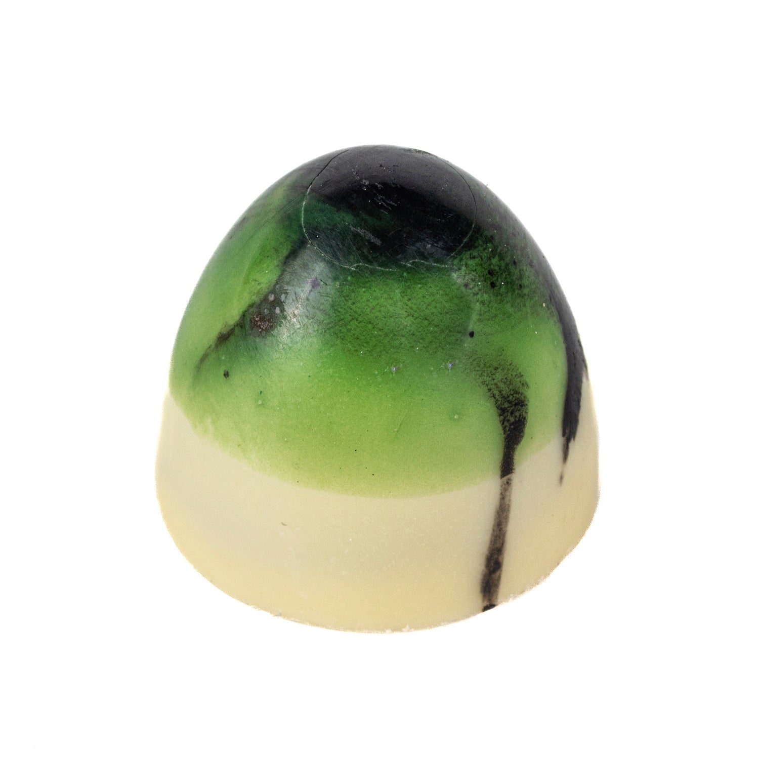Jag Couture London Coconut Bullet with white chocolate, milk chocolate coconut, and lime ganache, 10g, close-up of the confection.