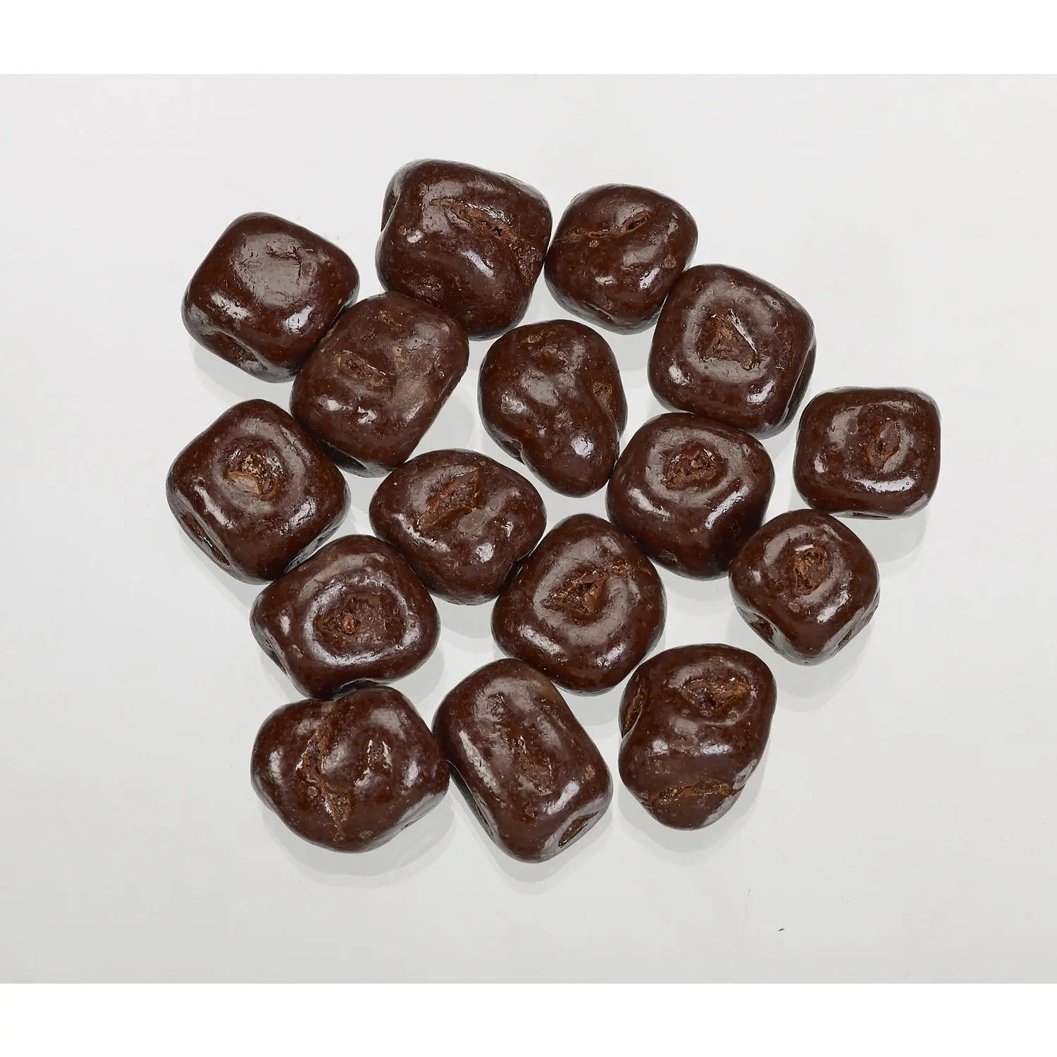 Dark chocolate covered ginger by Jag Couture London - New York, close-up of glossy chocolate coating on spicy ginger pieces.