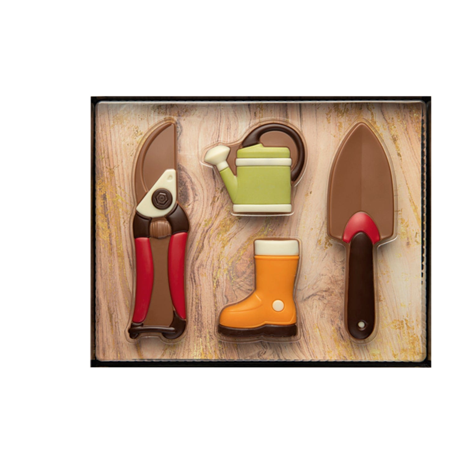 Decorated hollow milk chocolate gardening gift set from Jag Couture London New York, featuring detailed chocolate garden tools and decorations.