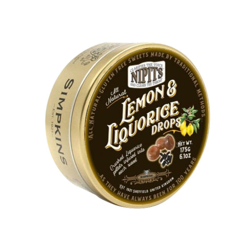 Gold tin of lemon and liquorice flavor Nipit travel sweets by Jag Couture London New York, featuring colorful sweets inside.