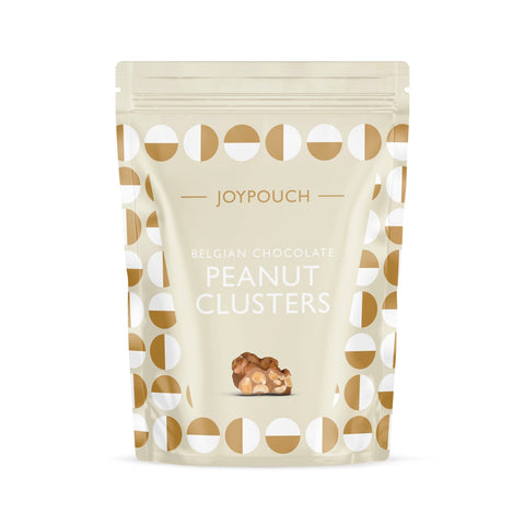 Milk chocolate covered peanut clusters by Jag Couture London-New York, showcasing glossy chocolate coating and crunchy peanuts inside.