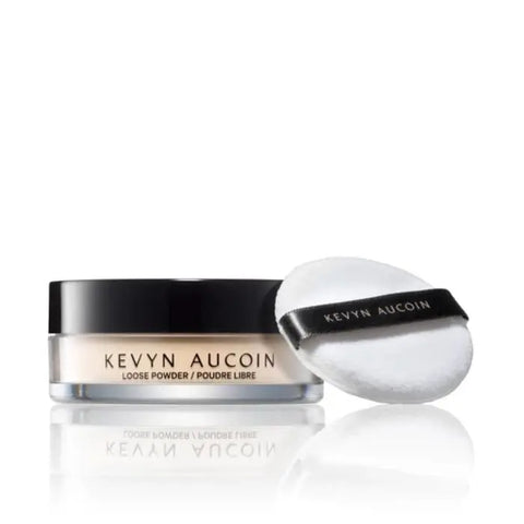 Loose setting powder by Kevyn Aucoin, displayed in a clear container, on a neutral background showing the product label.